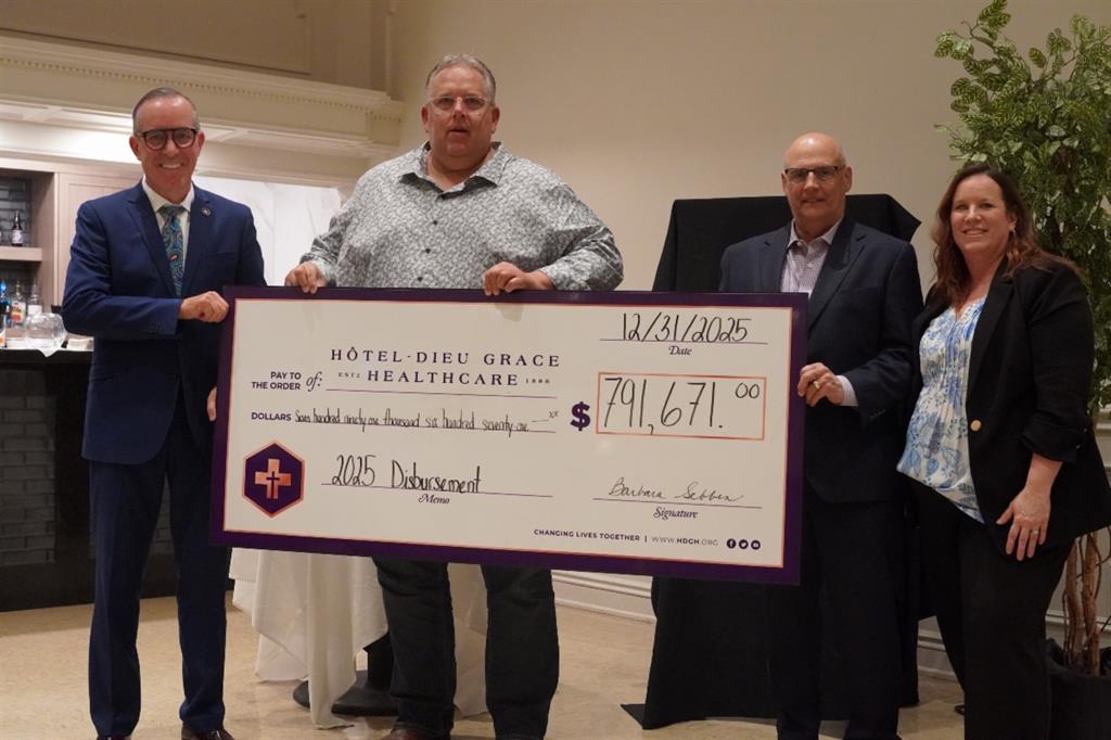 Bill Marra, Barb Sebben, and Board Chairs holding a cheque for $791671